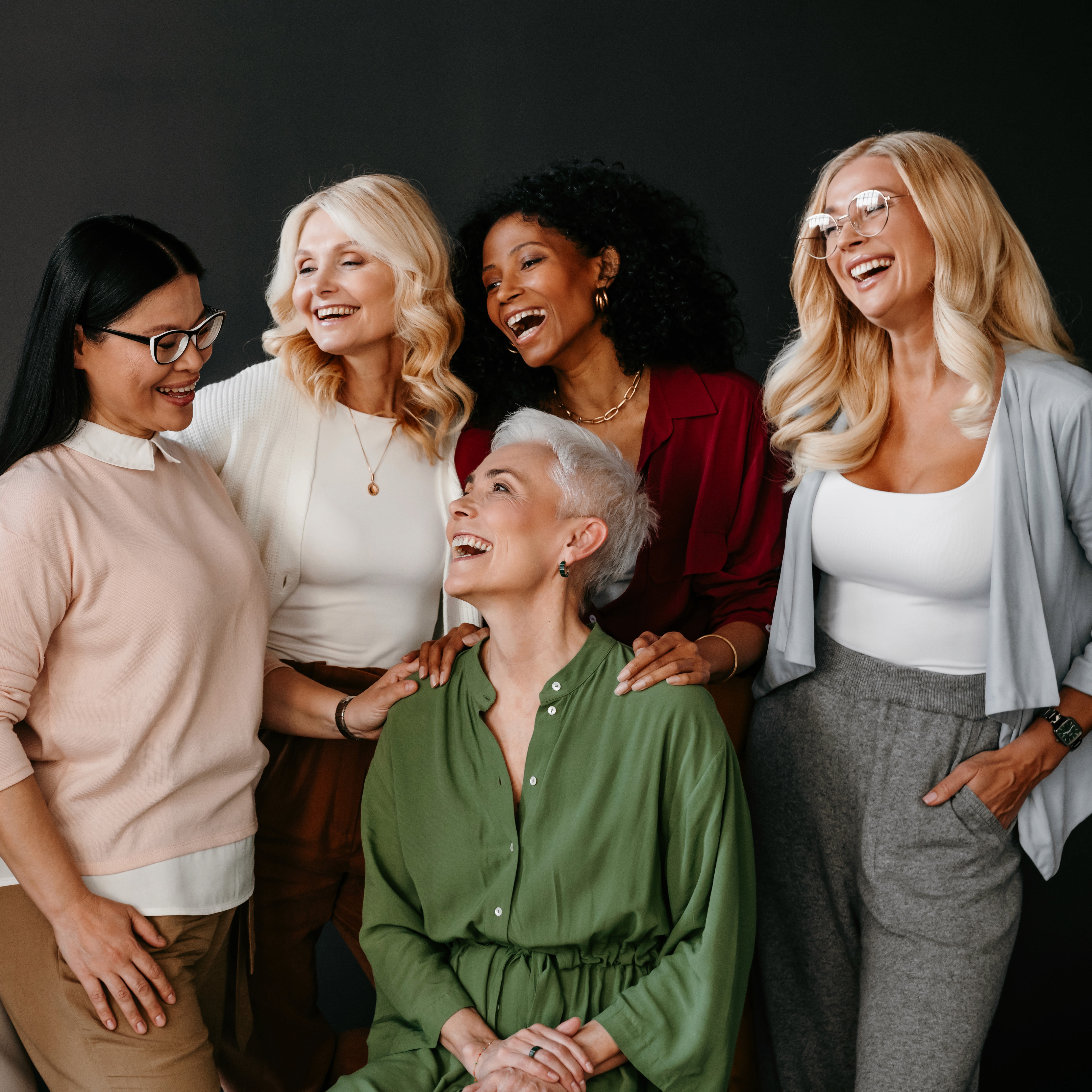 Women of different ages and backgrounds smiling together, illustrating the clinic’s community services at Venus Women’s Clinic