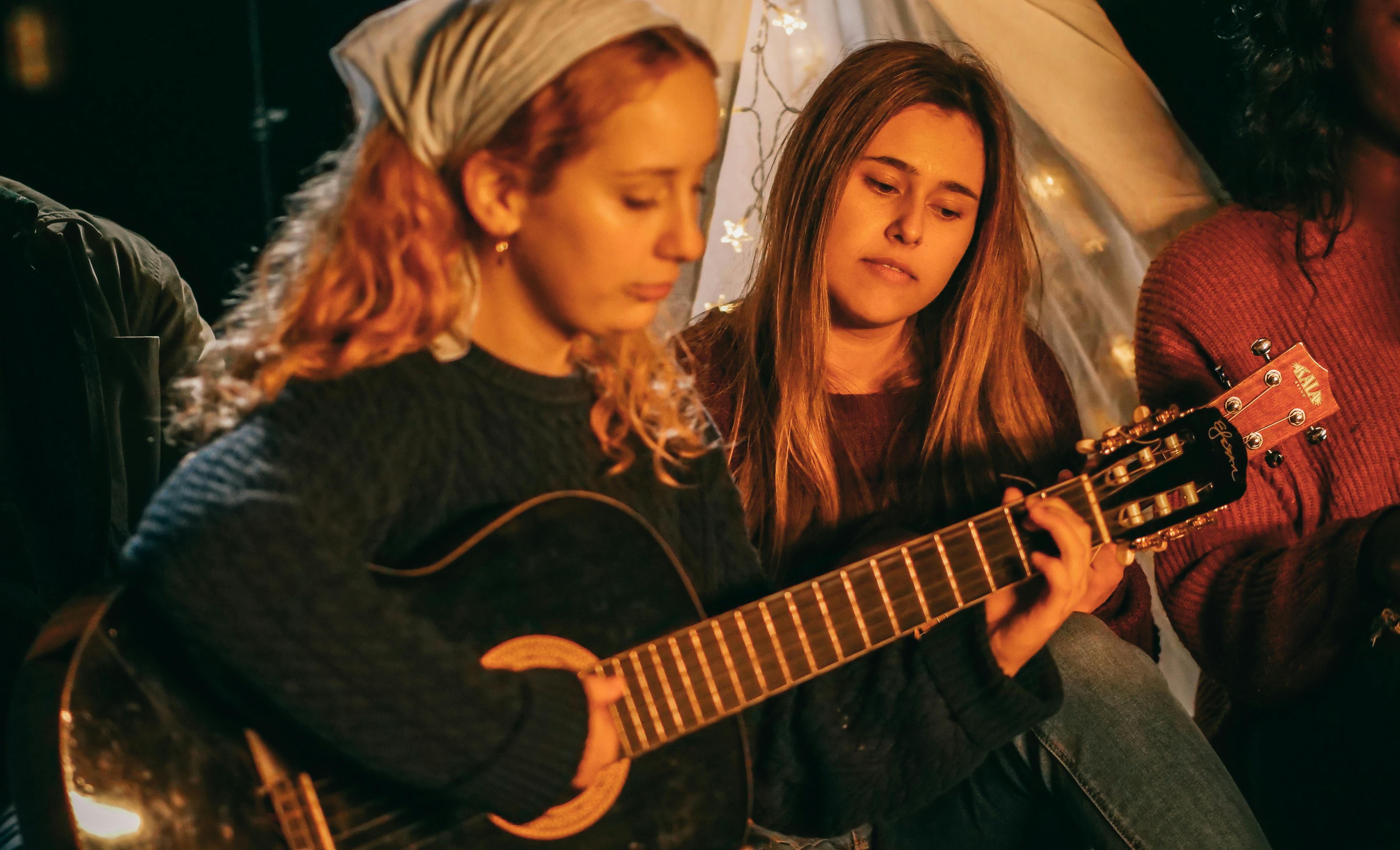 young people playing guitar