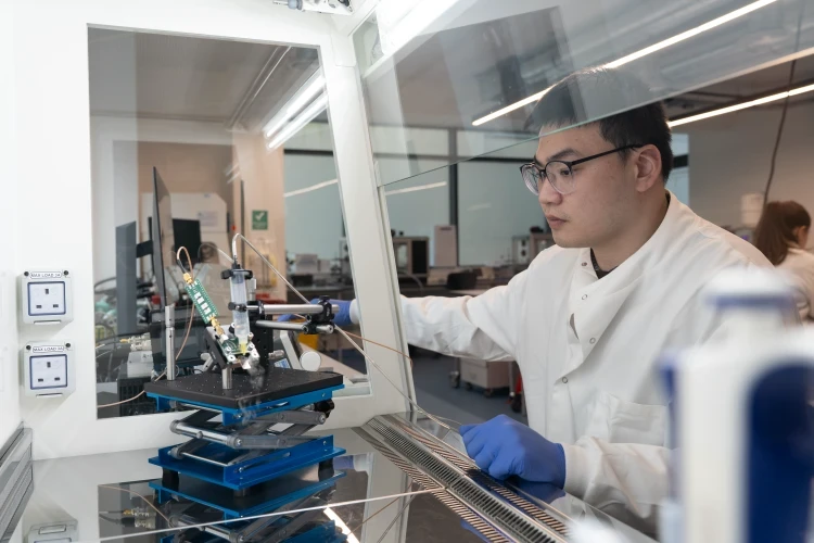 Scientist working in a medical research laboratory with testing equipment