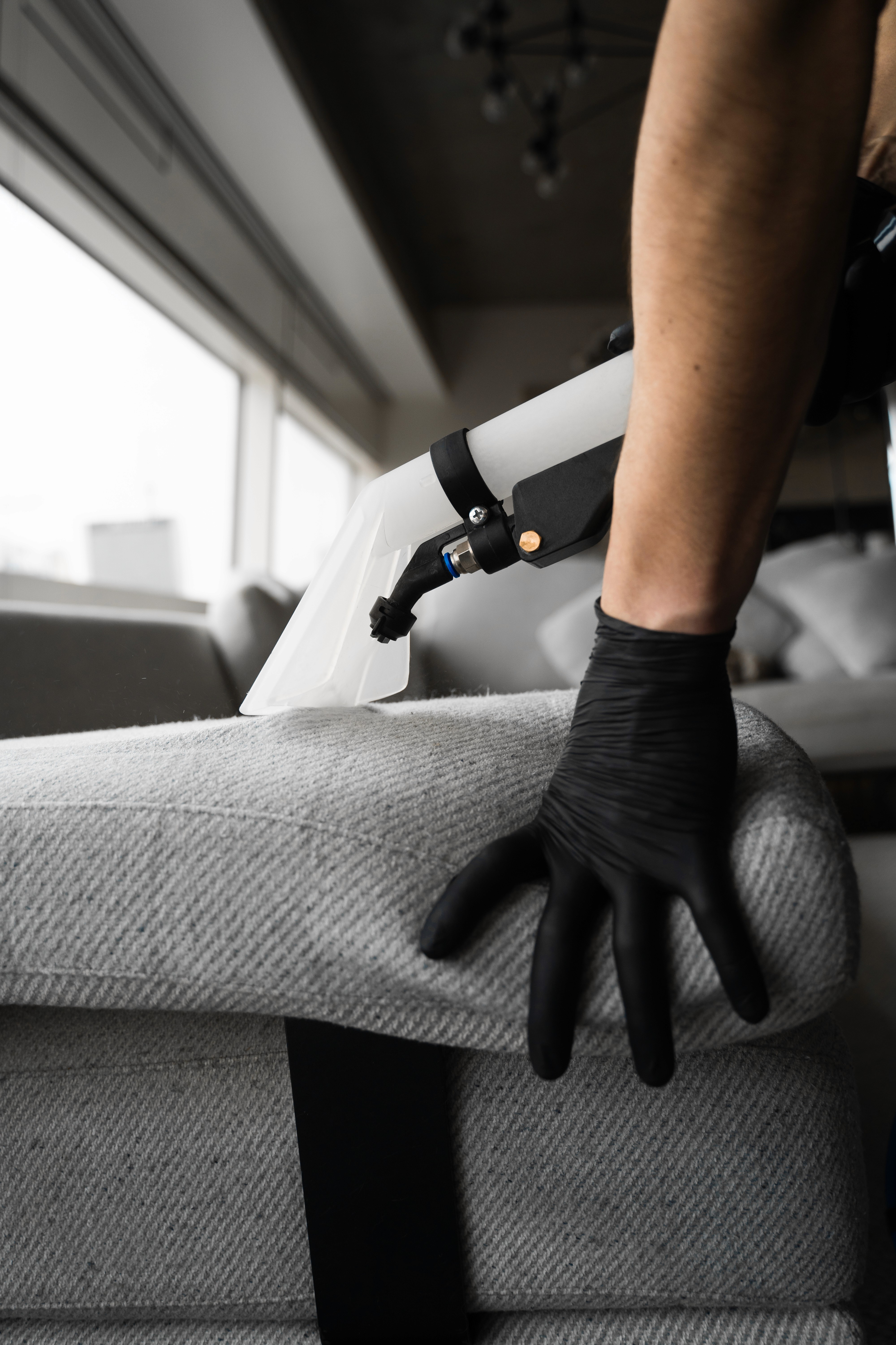 Technician cleaning commercial upholstered furniture