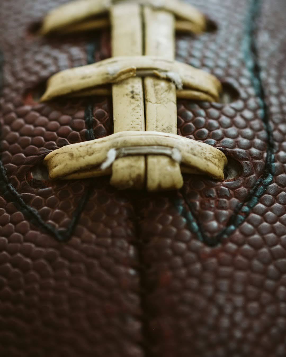 Close-up of a football with a leather strap, symbolizing the unexpected delay of Super Bowl XLVII, the Blackout Bowl.