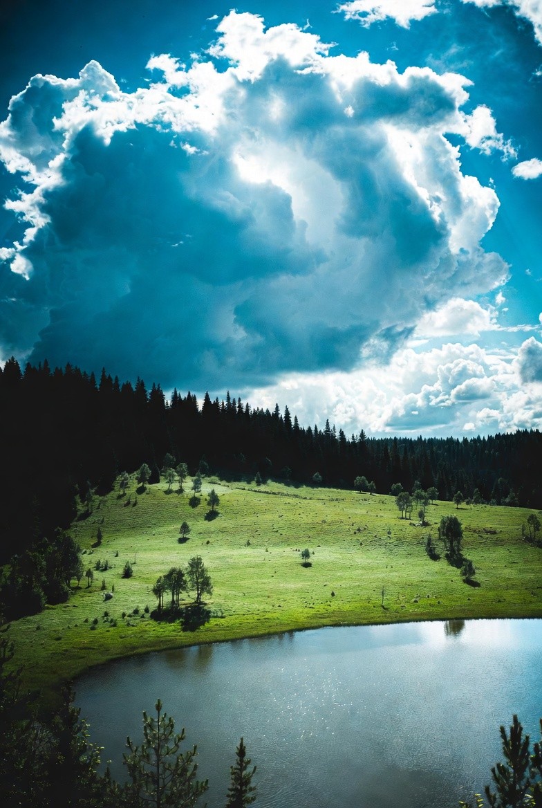 Top-down view of wind turbine over dry terrain with adjacent building