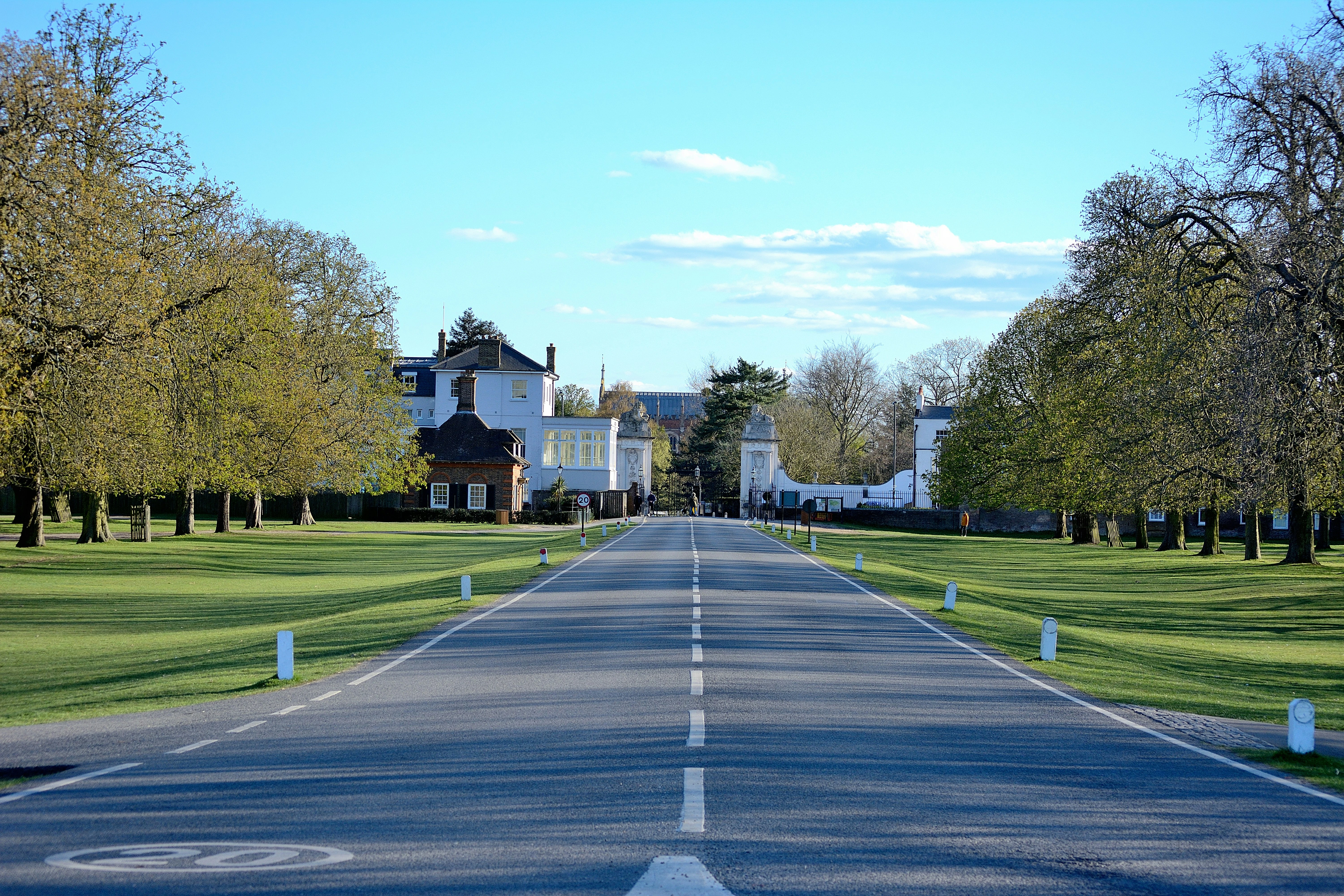 white and brown house near green grass field during daytime