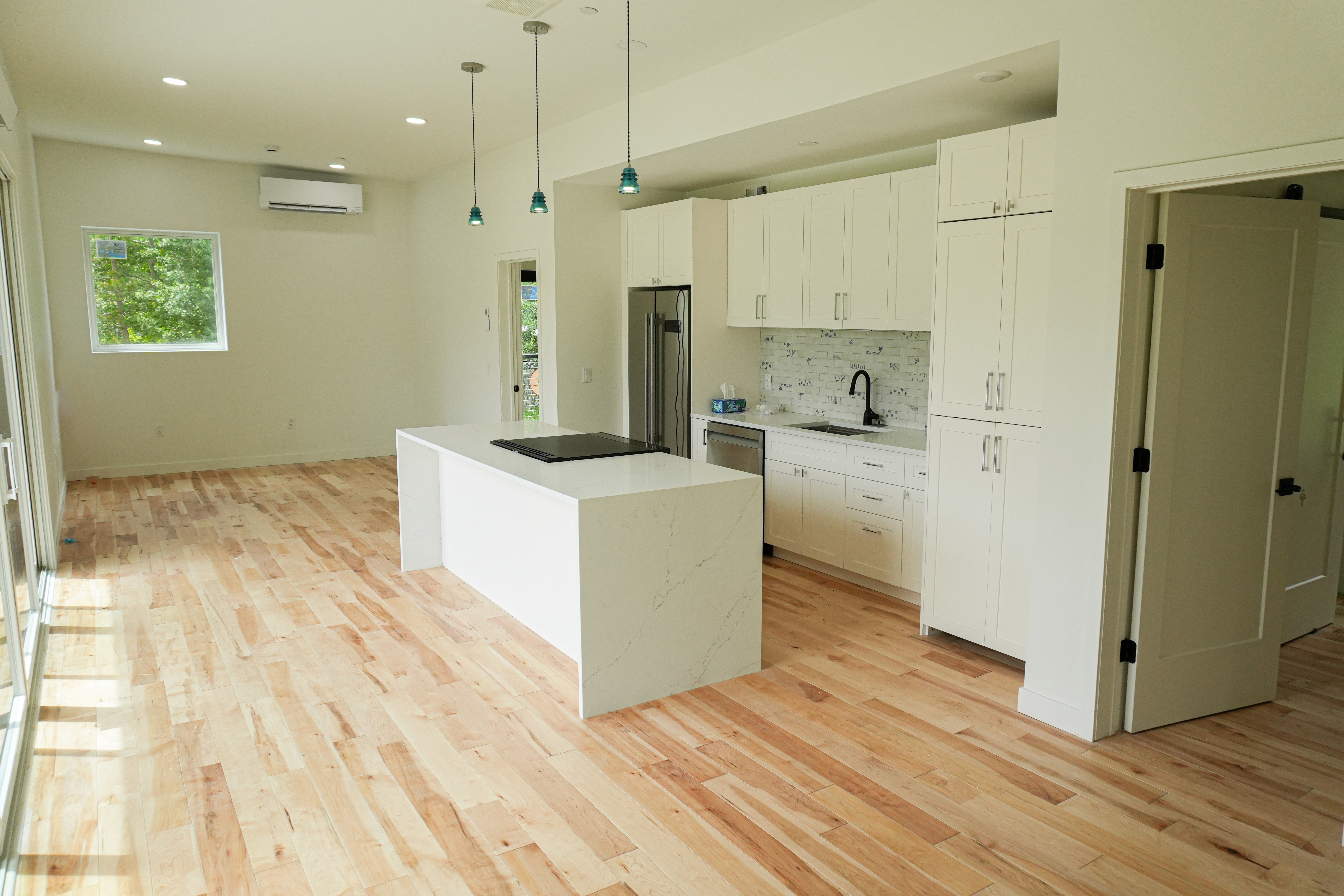 Modular home kitchen interior with a kitchen island with a stove.