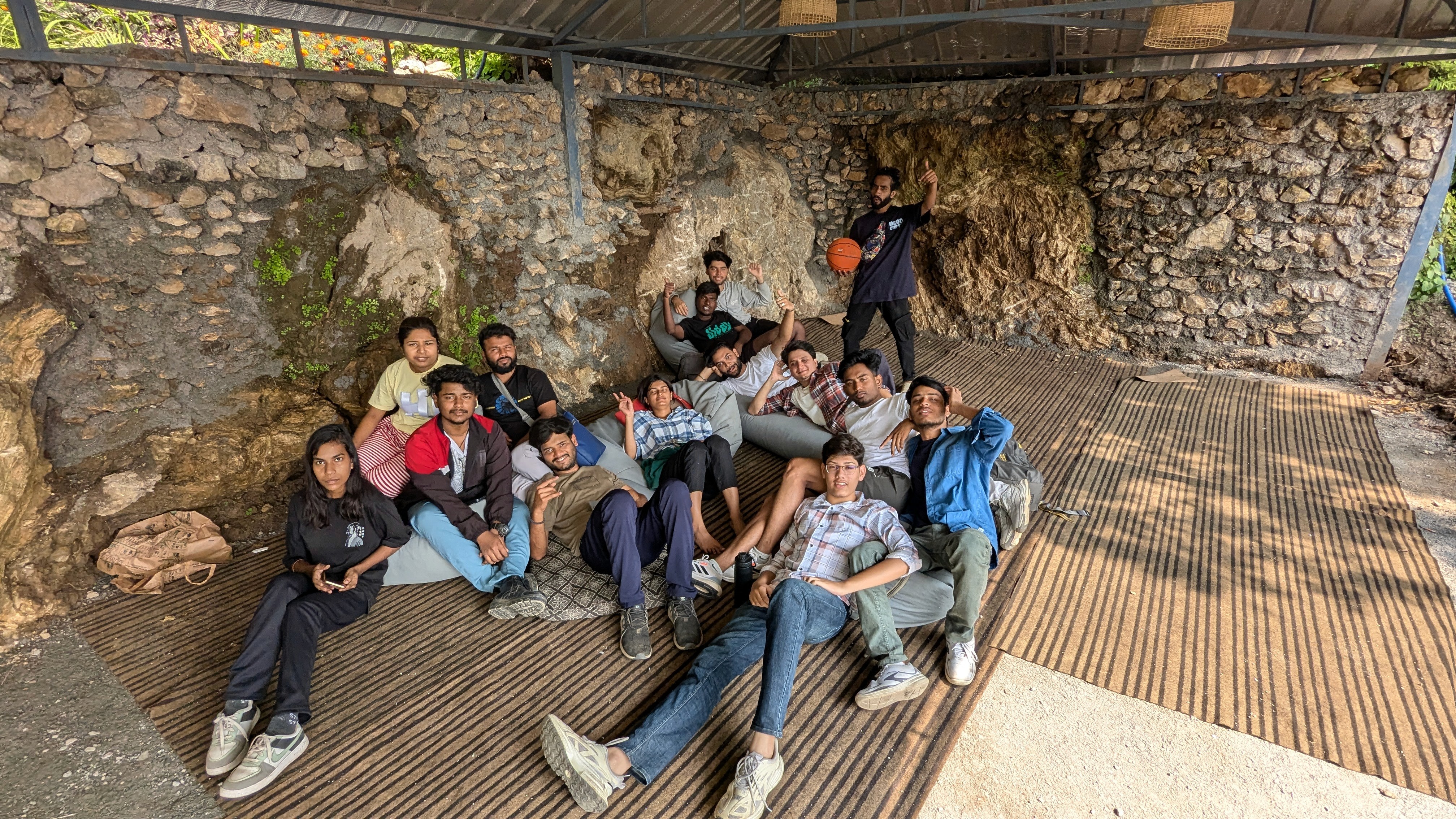 Wortham Rishikesh Trip  of a group of people lounging on a rocky surface, enjoying a sunny day outdoors. Team outing photo ideas