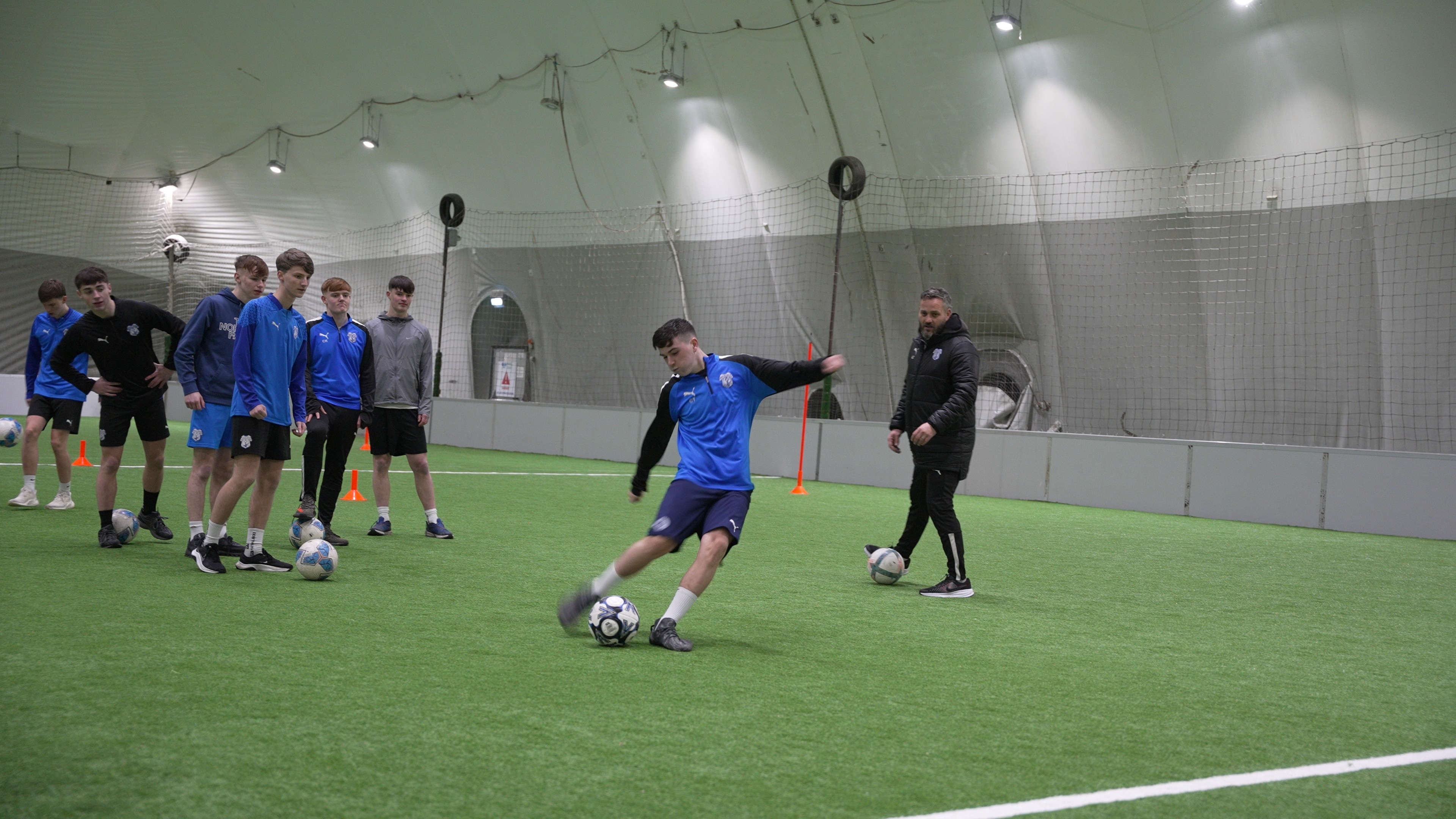 woman standing surrounded by exercise equipment
