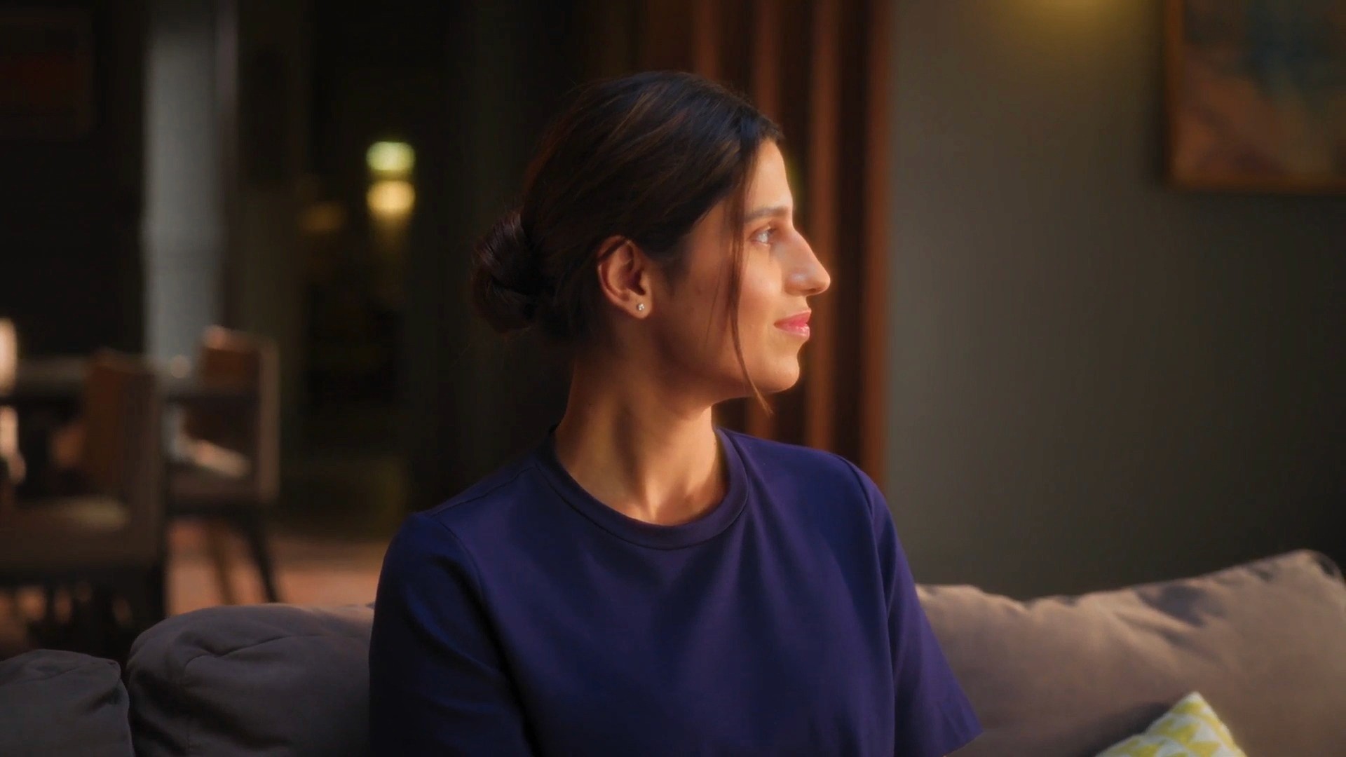 Woman relaxing at home in a lifestyle shot for a TOTO India product video.