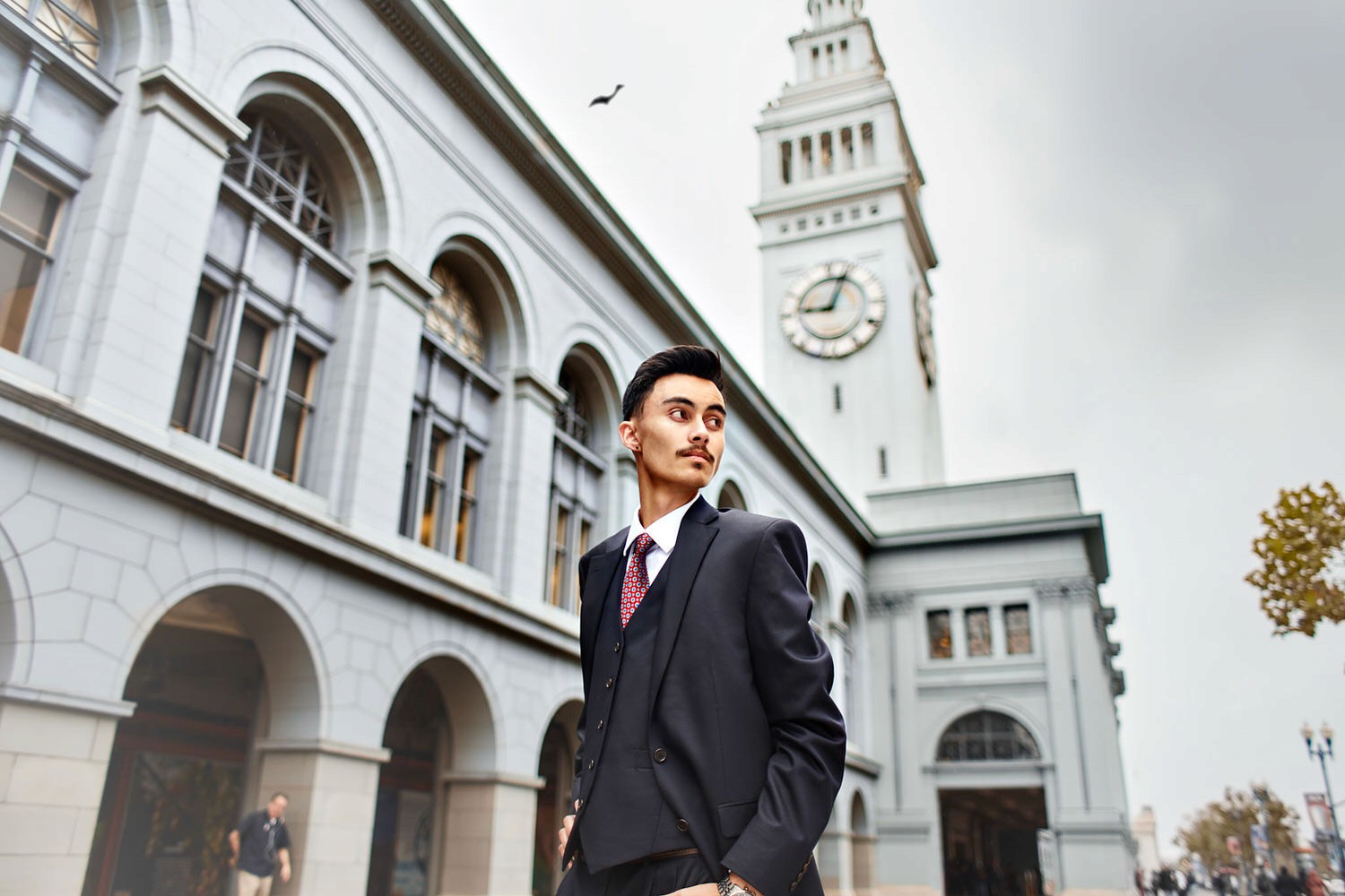 Professional portrait of man in suit outside San Francisco Ferry Building