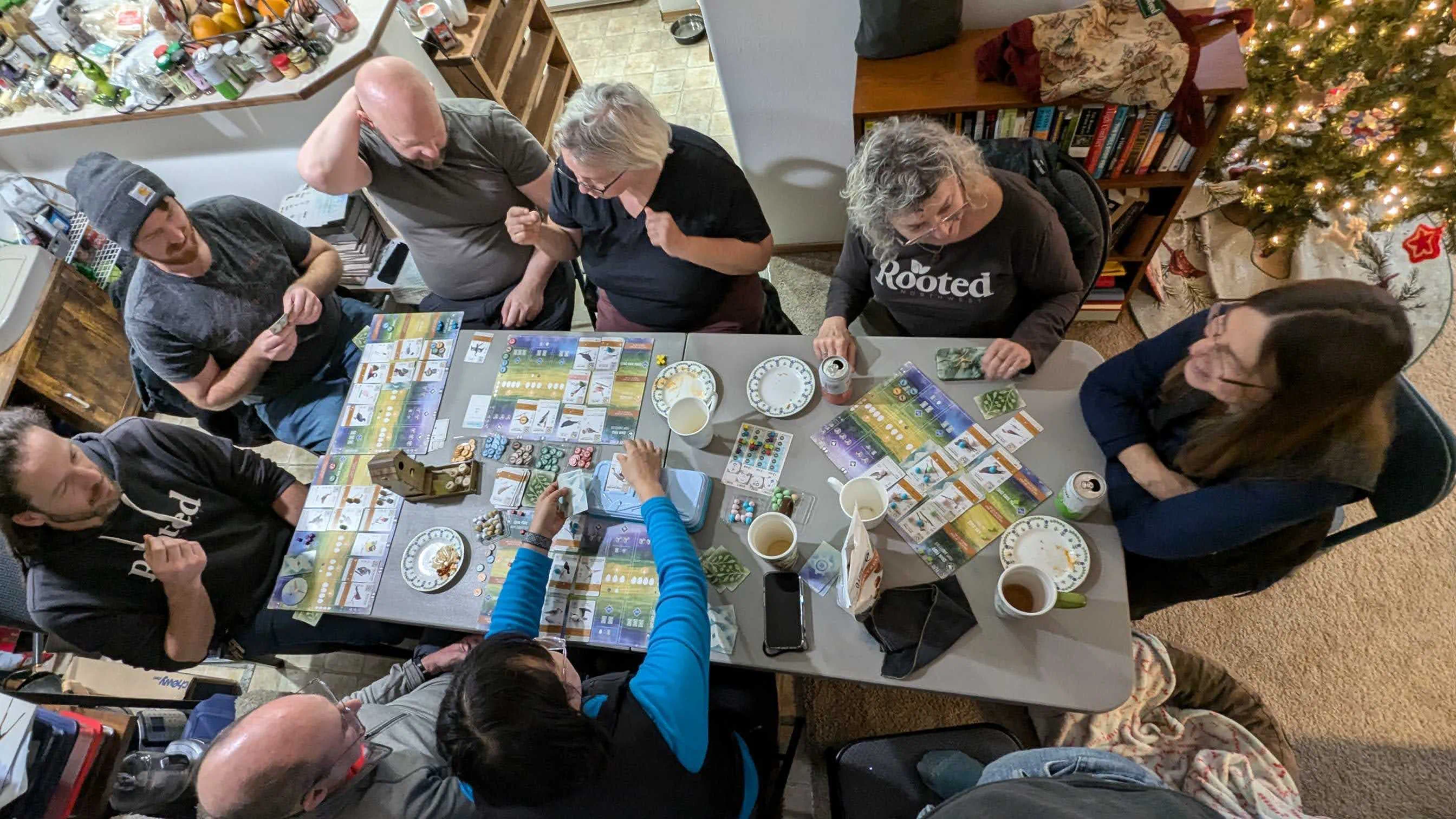 Neighbors gathered around a table, sharing conversation and activities during a community event.