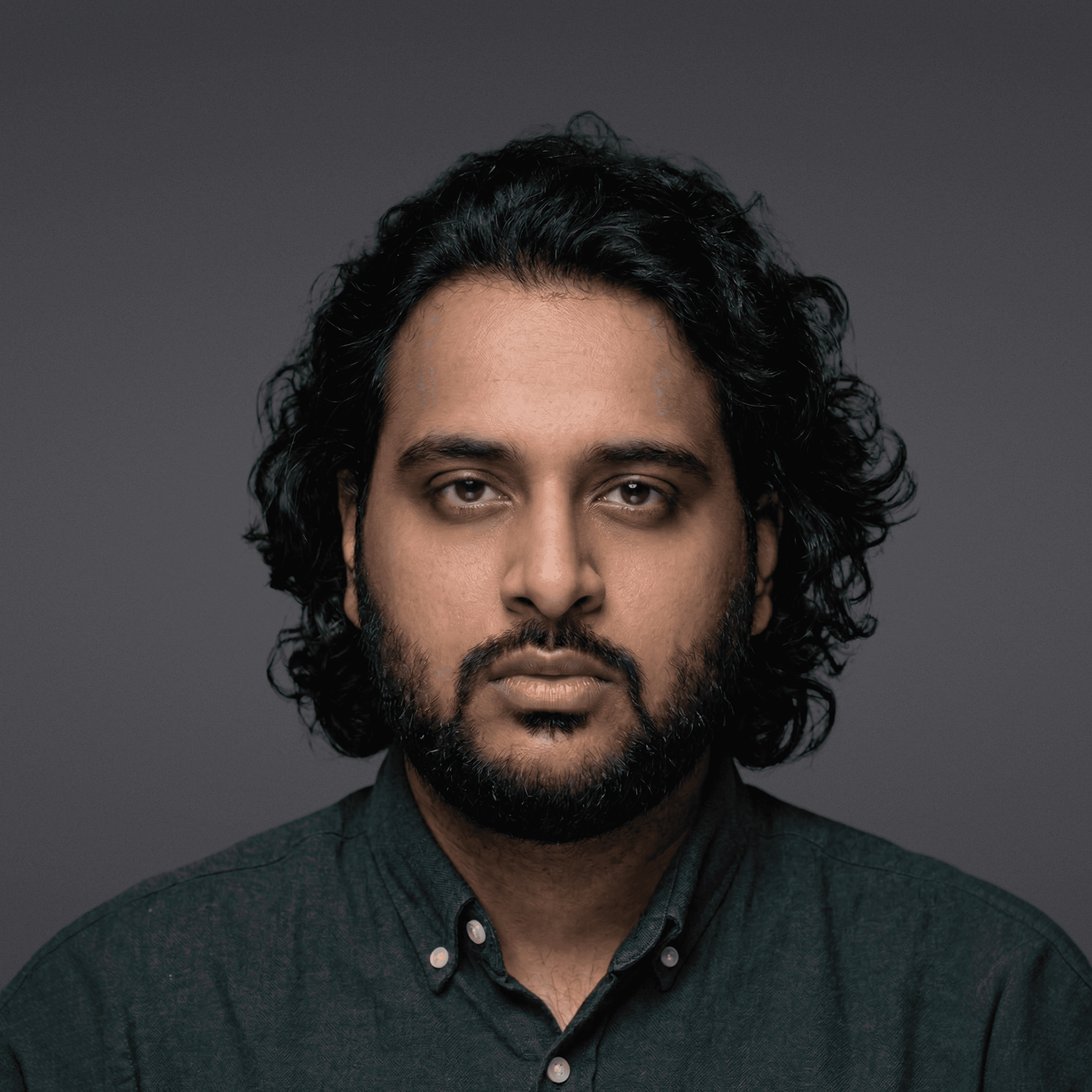 Black and white portrait of a man with a beard and glasses