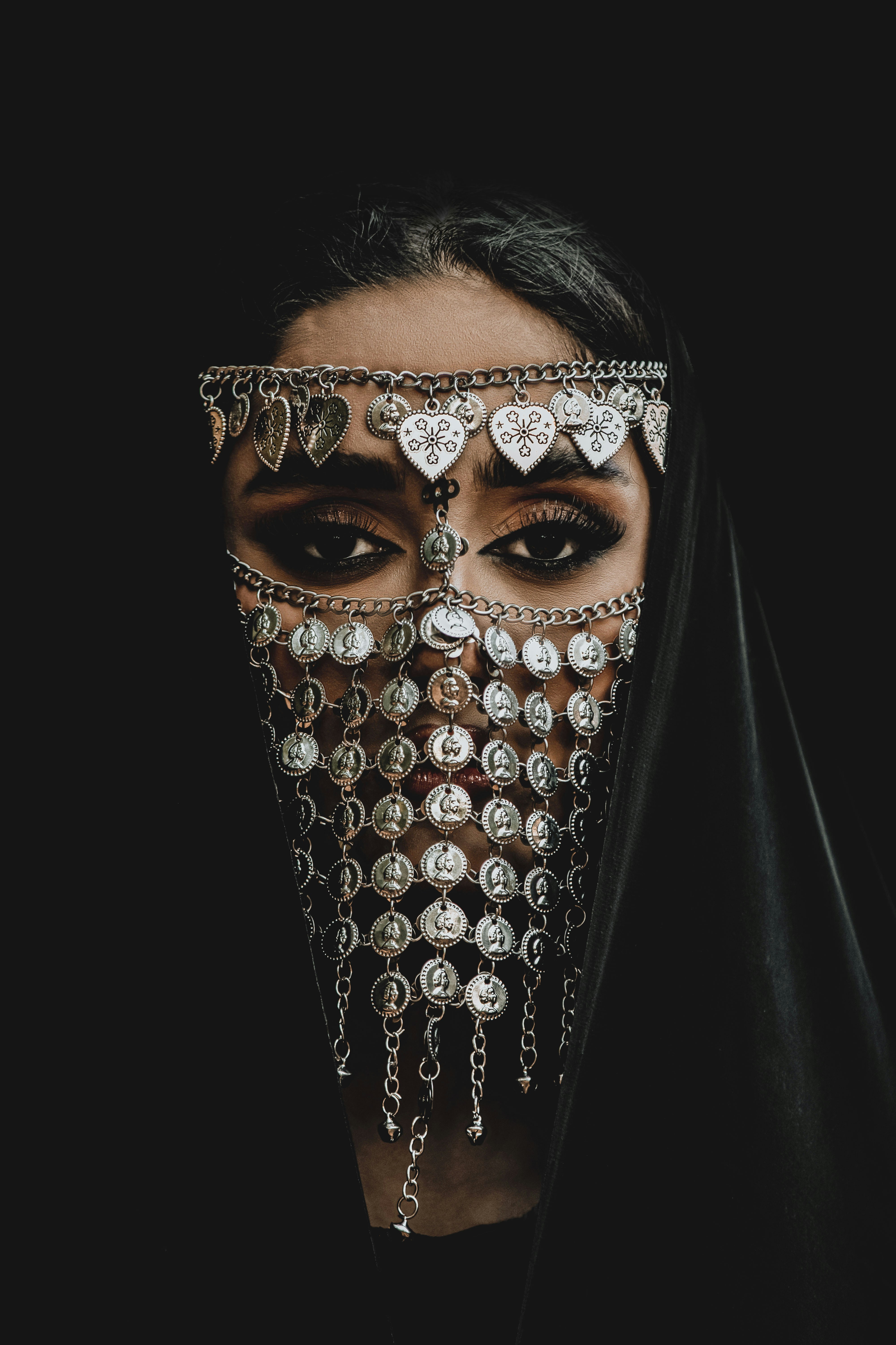 A woman wearing a veil and a face mask