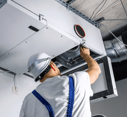 Technician installing an HRV ventilation system to improve indoor air quality in a Mississauga home
