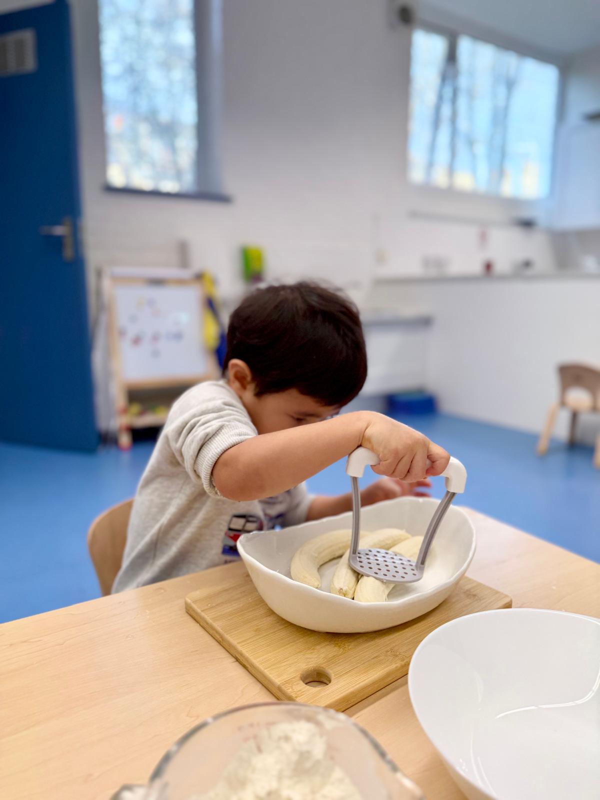 boy playing cube on white wooden table