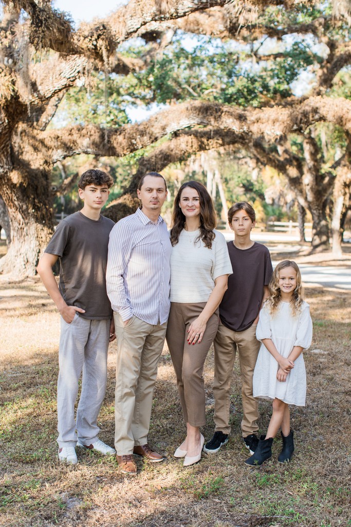 a group of children sitting on steps in front of a building