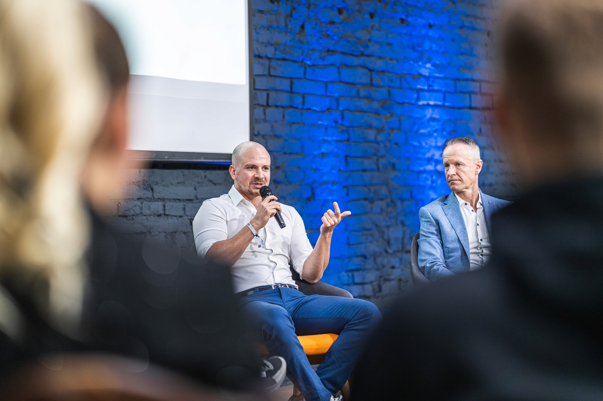 Speaker taking part in a panel discussion during a professional conference session.