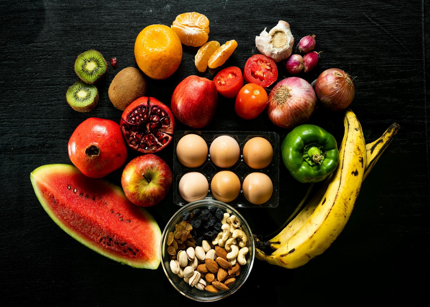 Various fruits, seeds, veggies and a half a dozen of eggs