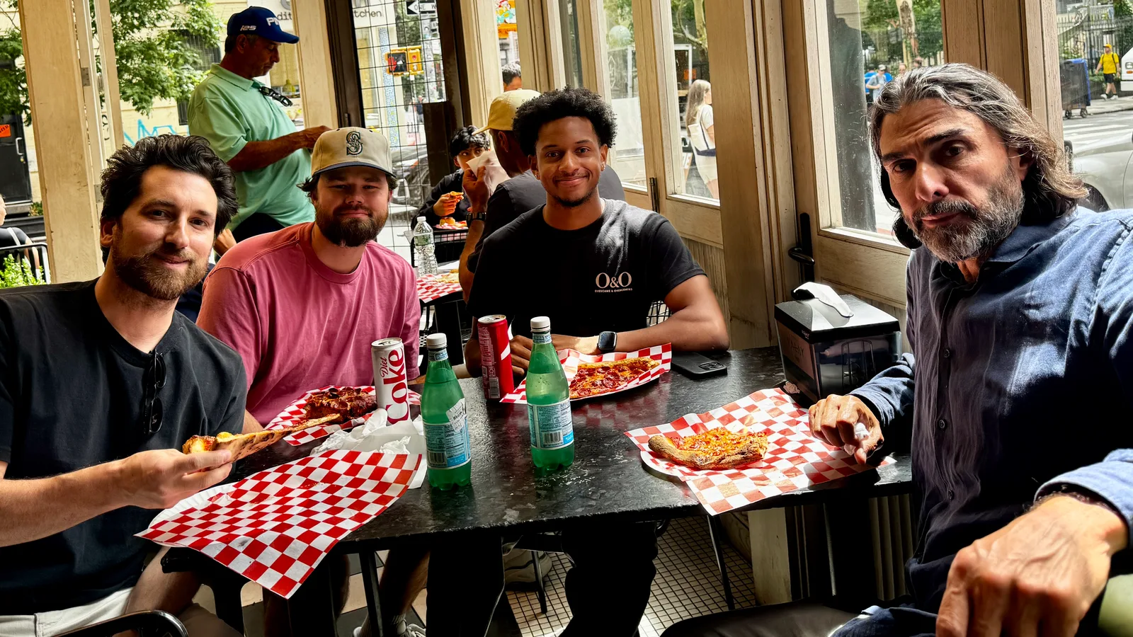 Justin Toussaint sharing pizza with the MIJO team in New York
