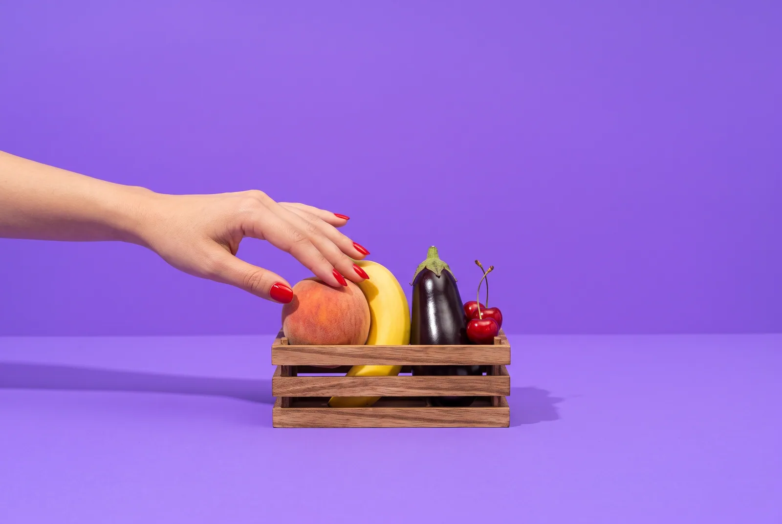 Fortify alternatives concept: a banana, a peach and an eggplant standing on a tiny three-step winners' podium