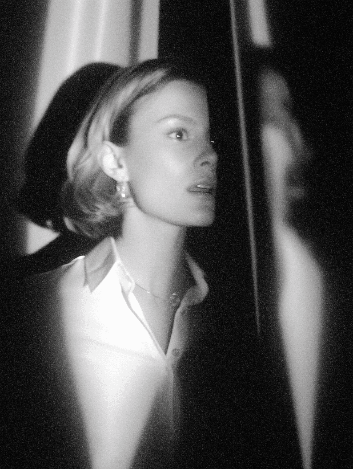 Woman in white blouse with sharp light and shadow contrast