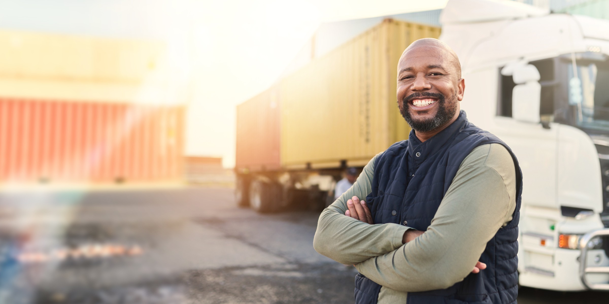 Man smiling standing in front of his truck