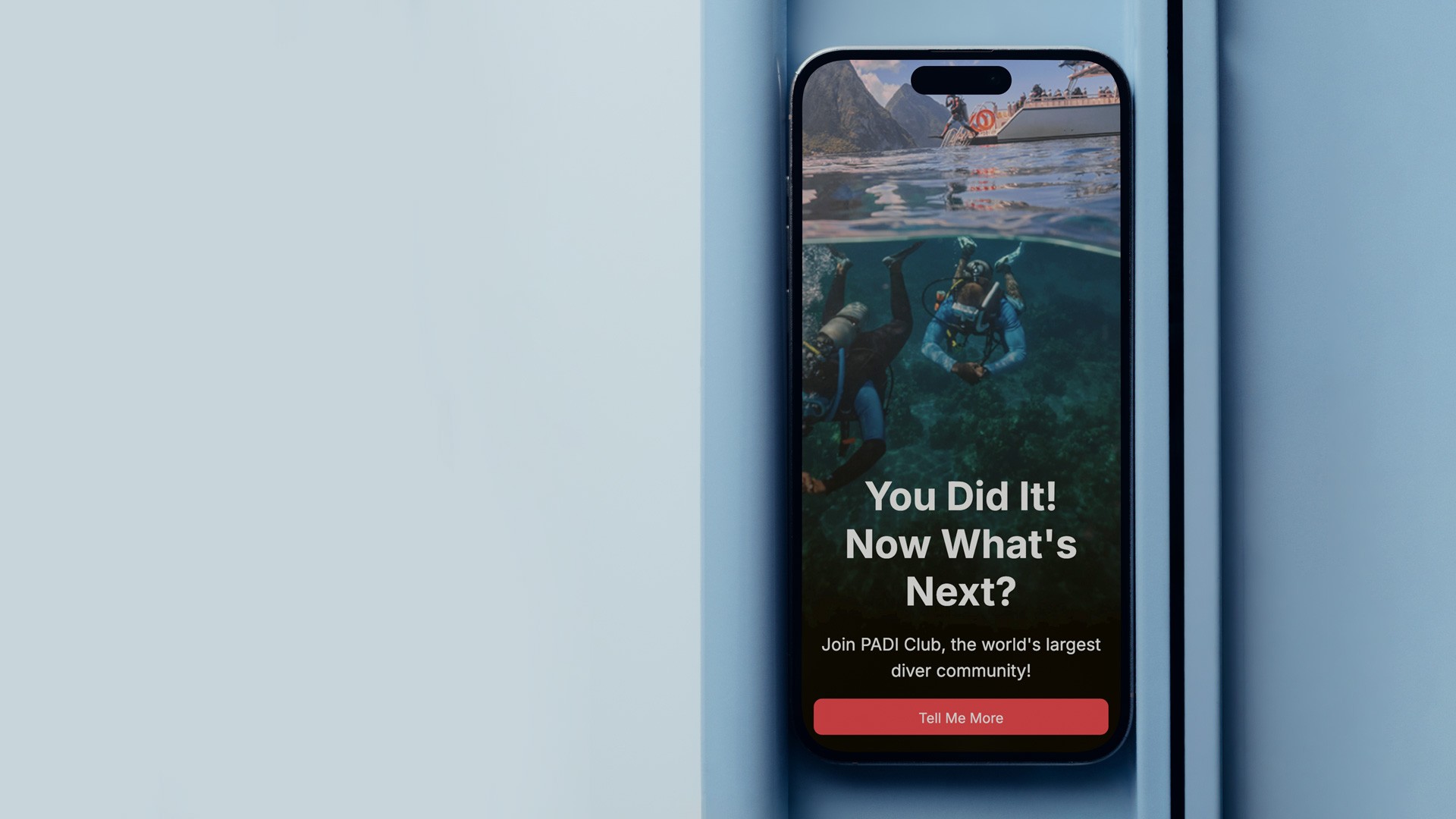 Smartphone displaying a PADI Club promotional email design featuring immersive split-view underwater photography, bold call-to-action messaging, and mobile-first layout created within PADI’s branded email system.
