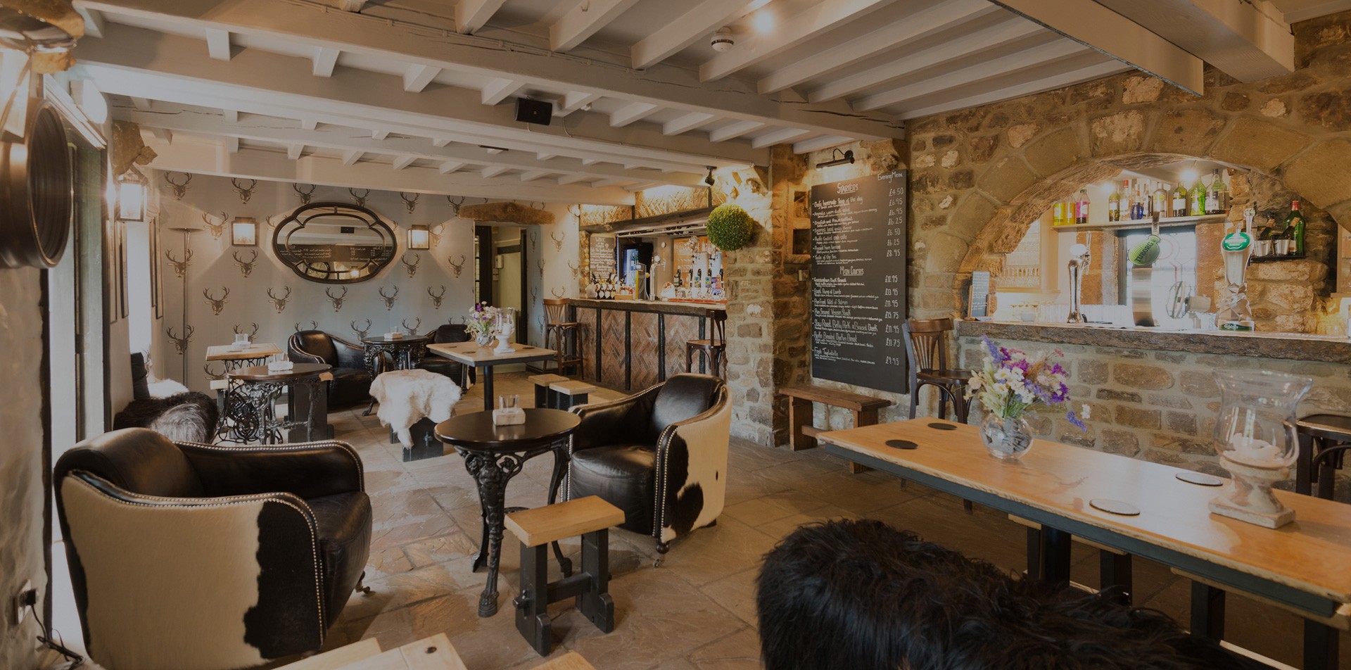 Rustic country pub interior with exposed wooden beams, stone walls and cozy dining area, traditional British inn atmosphere