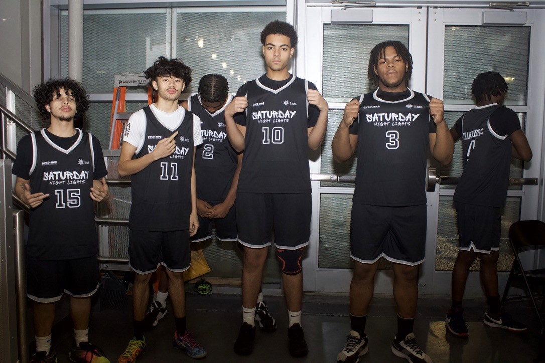 Basketball team shows off their jerseys before a game.