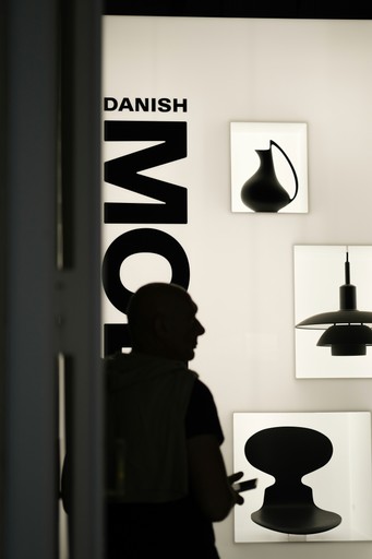 A man standing in front of a display of lamps