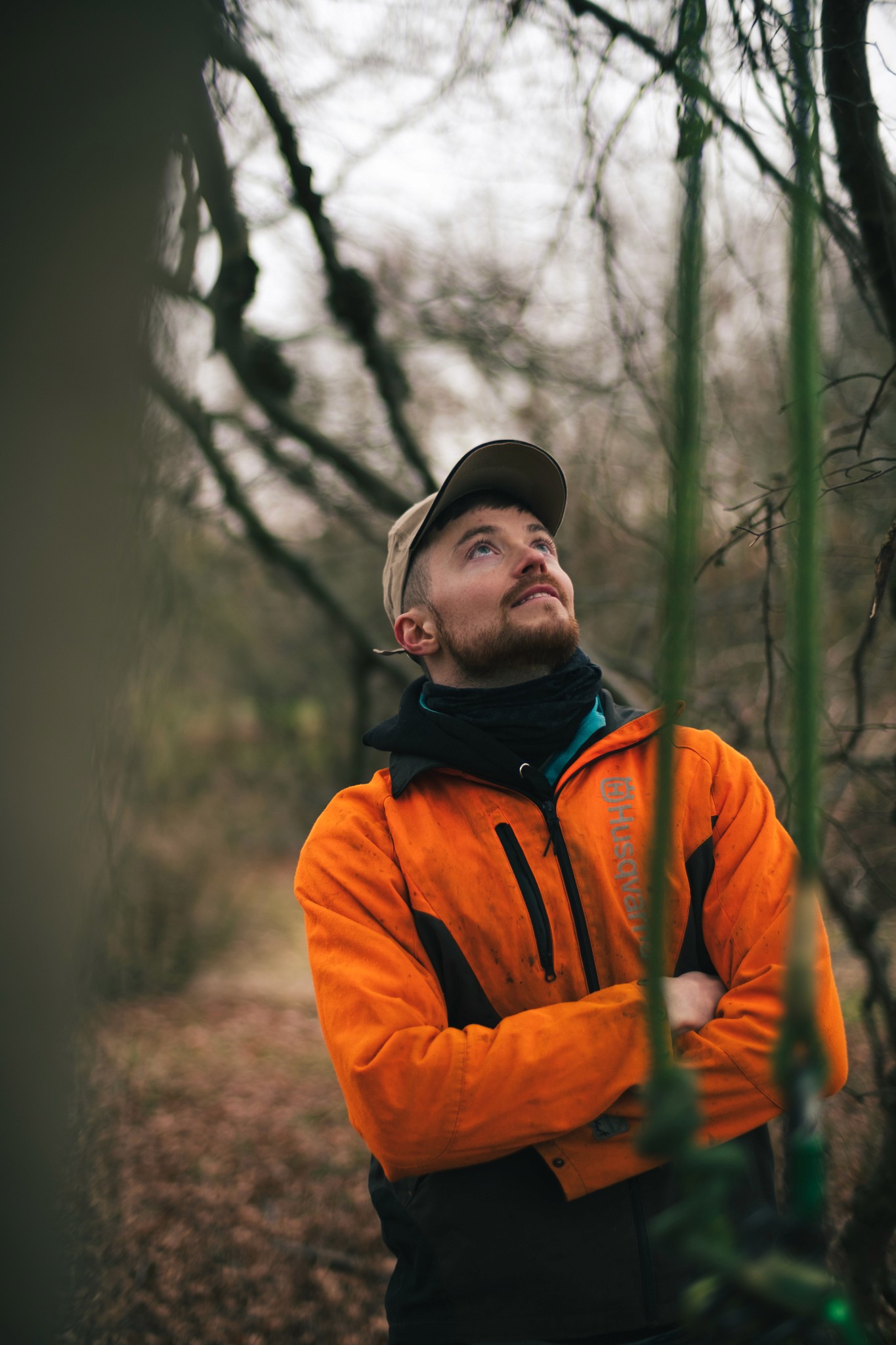 Close-up of a sleek dark green SUV with modern design elements, illuminated against a dark green background.