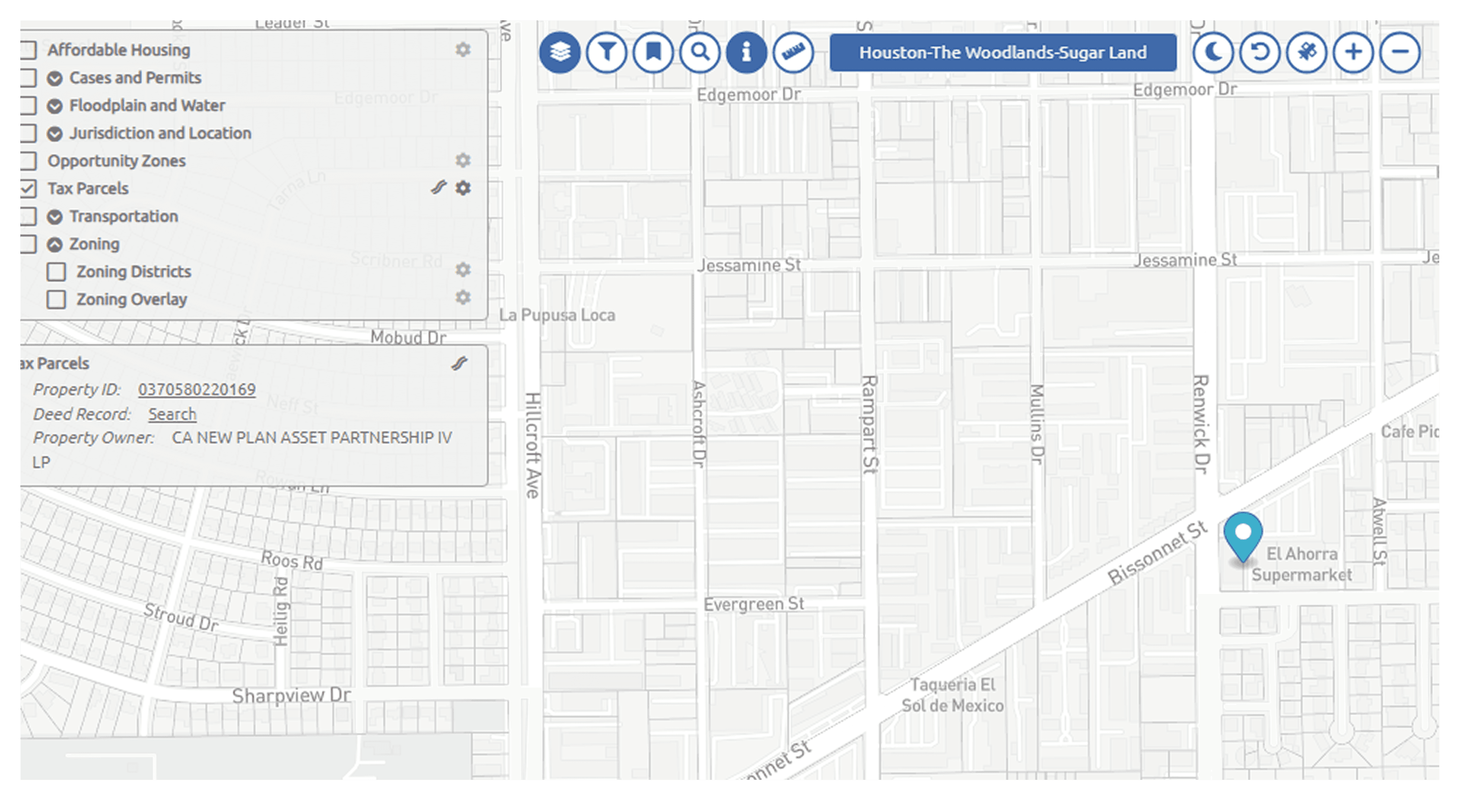 A large orange truck driving down a dirt road