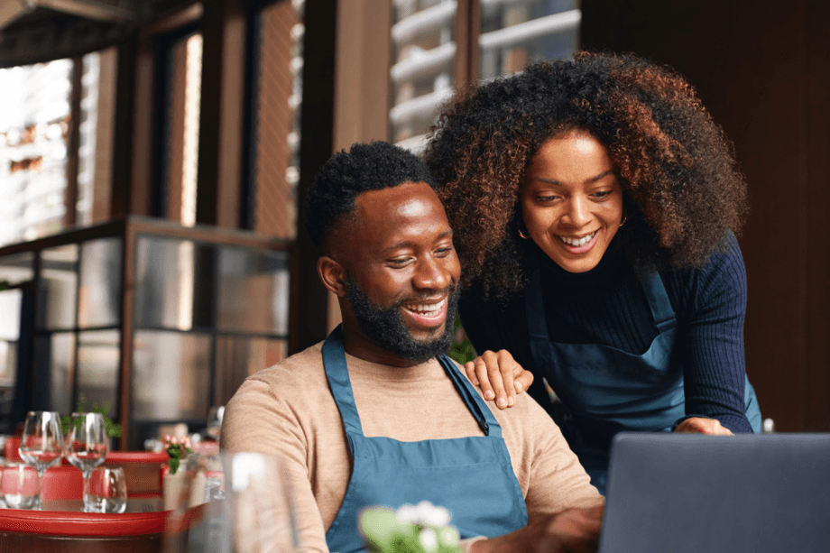 Two People Looking at Laptop