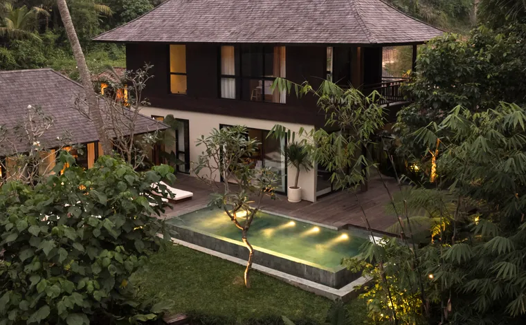 Cozy Denpasar property at night with illuminated pool area, perfect for residential real estate investment.