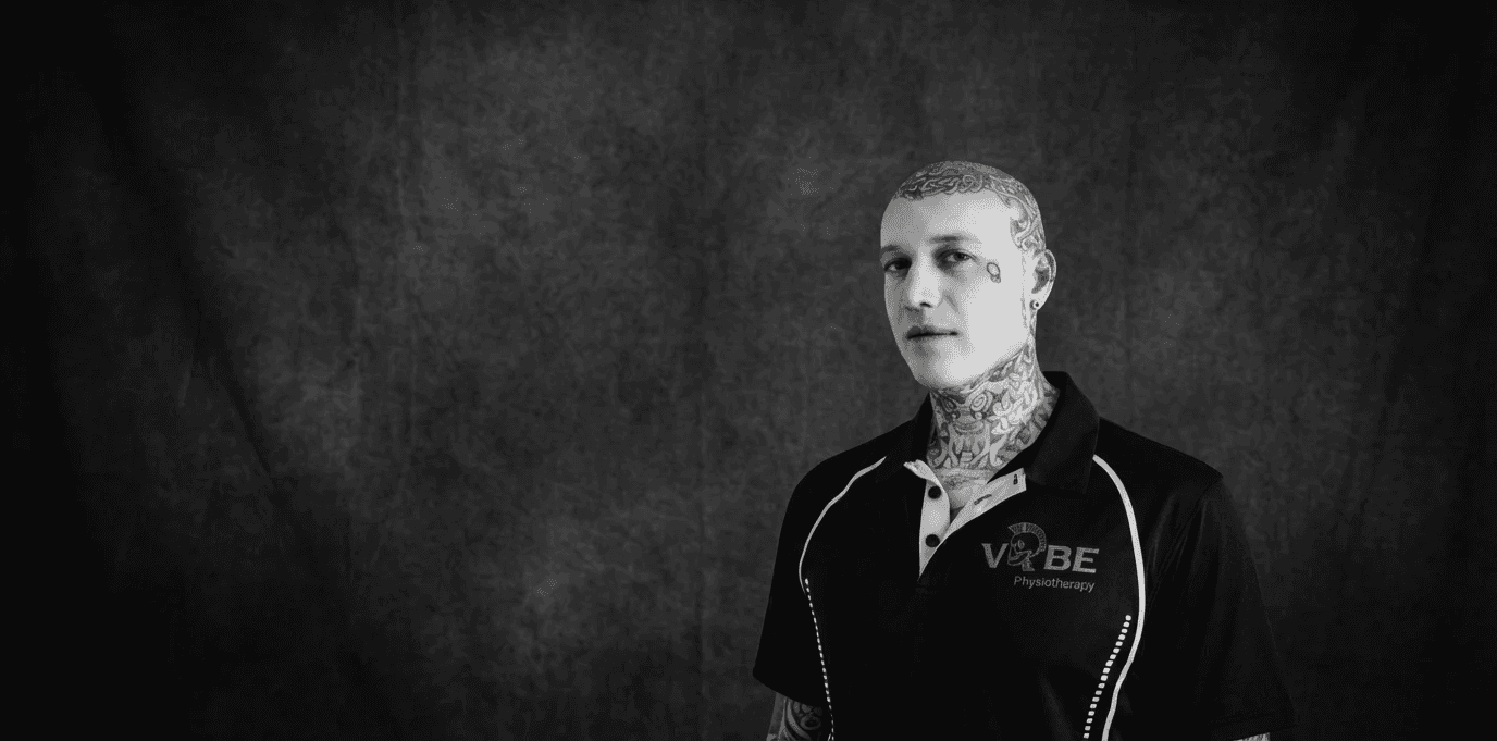 Modern indoor space with large glass doors, lush greenery, and a cozy seating area visible beyond.