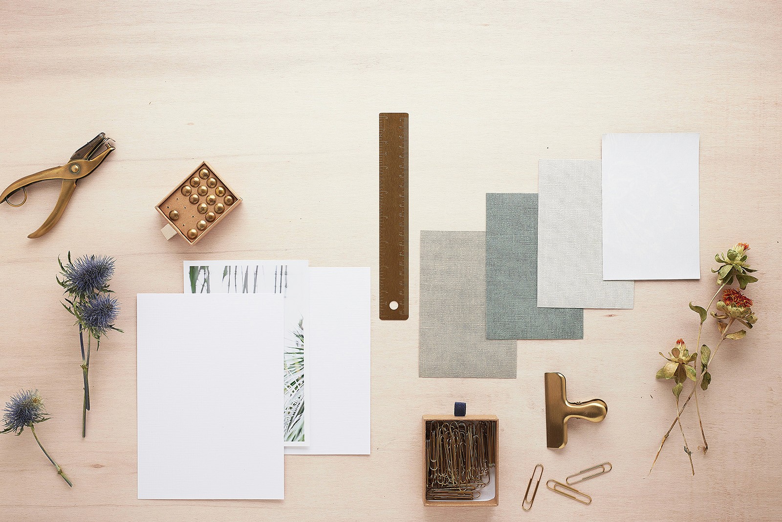 Materials and stationery scatted neatly laid out on a desk