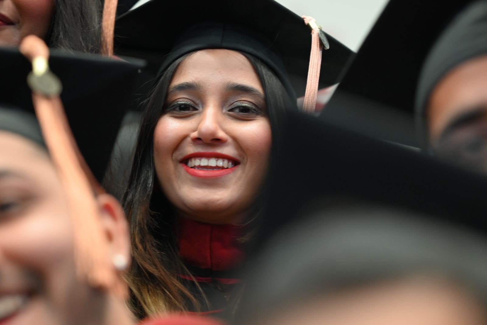 Blurry black-and-white figure in cap, white shirt, and black trousers.