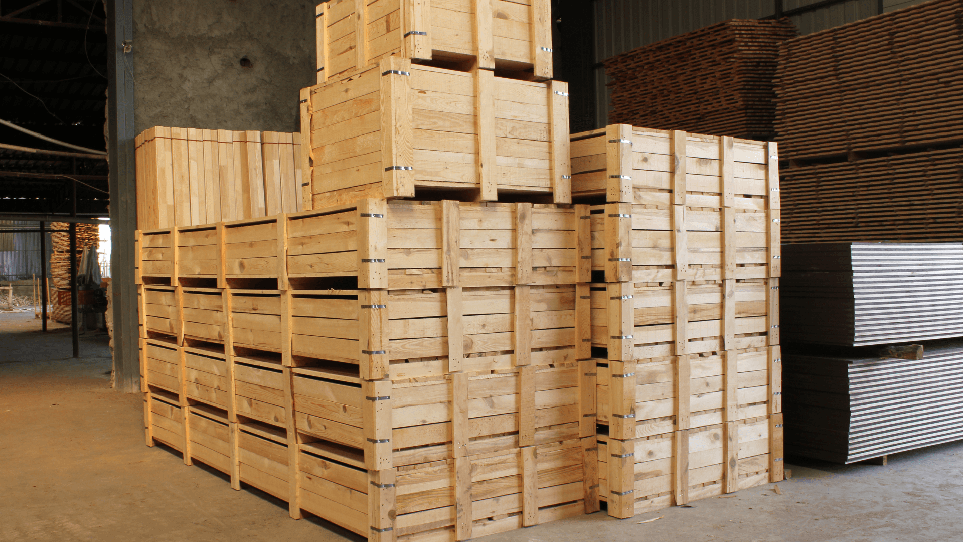 Large wooden export crates stacked in a warehouse facility awaiting shipment.