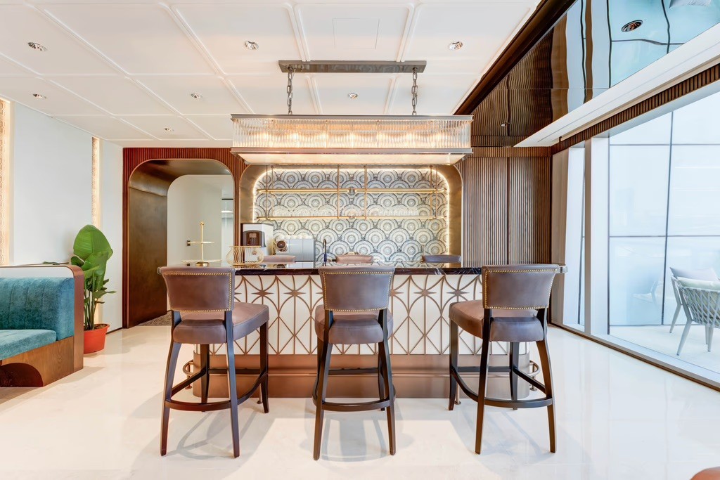 Large conference table in a well-lit space with a screen and city views.