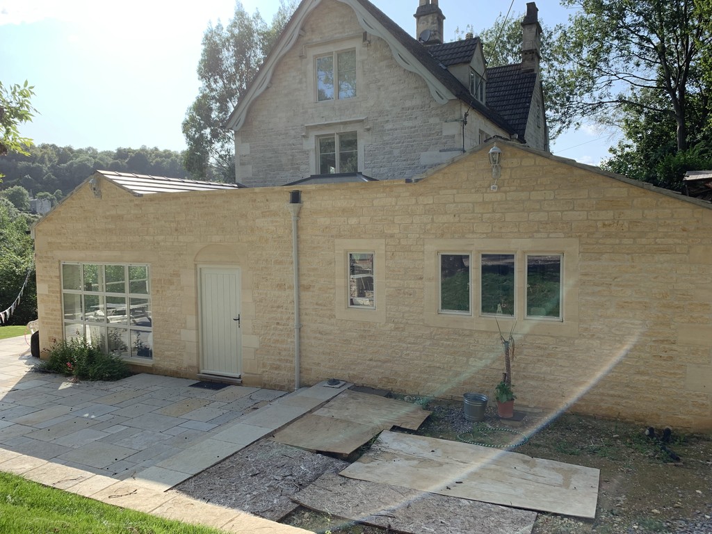 A natural single storey stone wall extension on a cotswolds building 