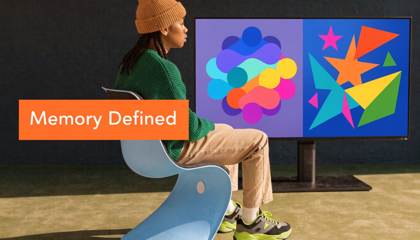 A person sitting on a blue chair watching a screen display vibrant abstract shapes and colors.
