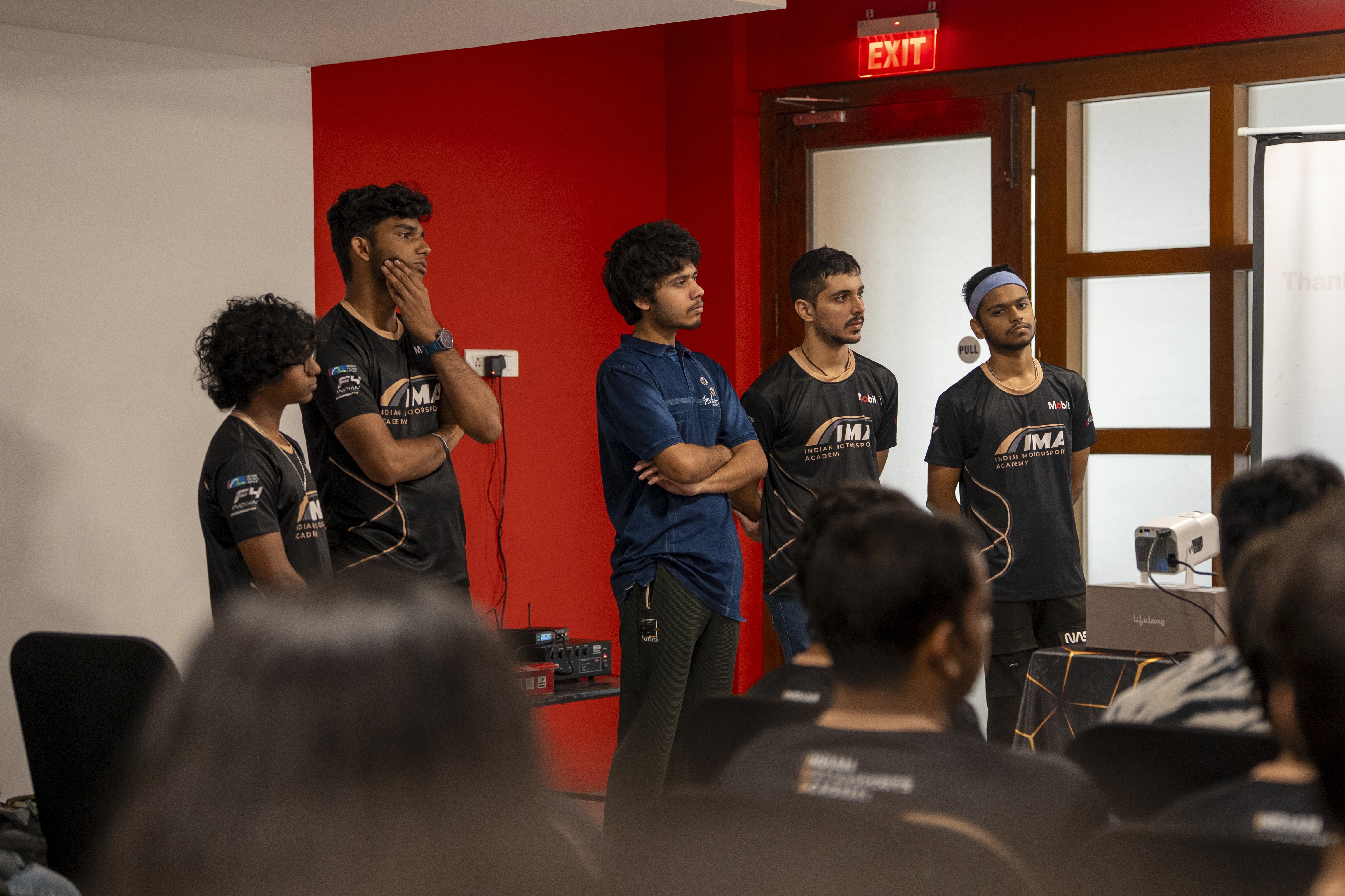 A man stading with Surfboard