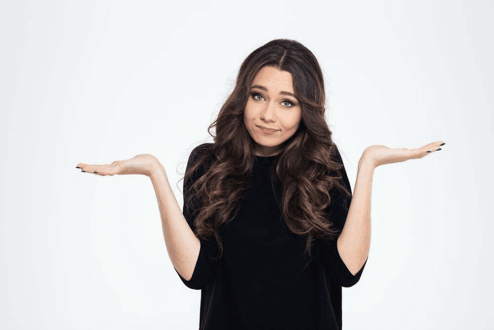 Person in a black dress posing with their arms outstretched.