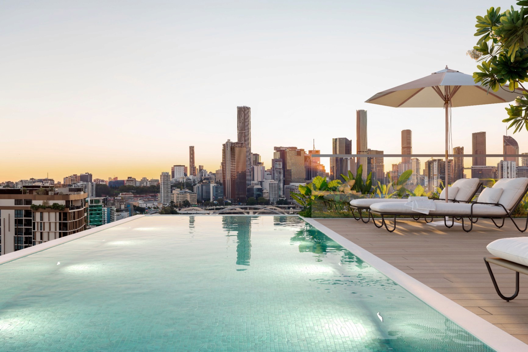 Rooftop infinity pool at Quartet Milton with panoramic Brisbane skyline views, resort-style amenities in inner-city apartments