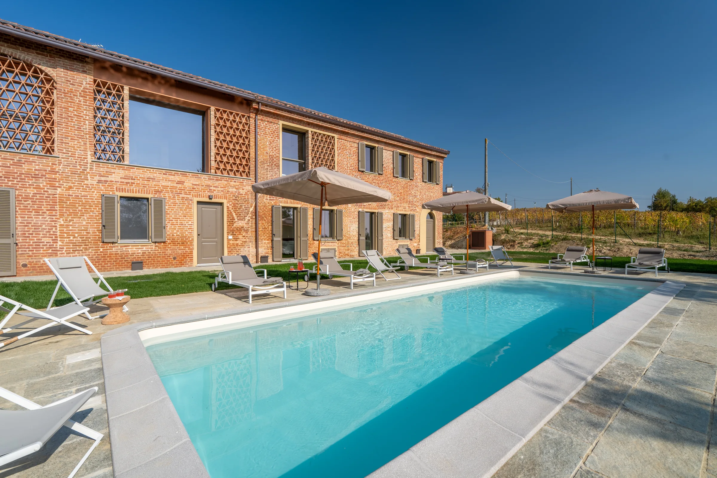 Swimming pool beside the villa in daylight — Fubine Monferrato, Italy. Photography by Yunes Calore.