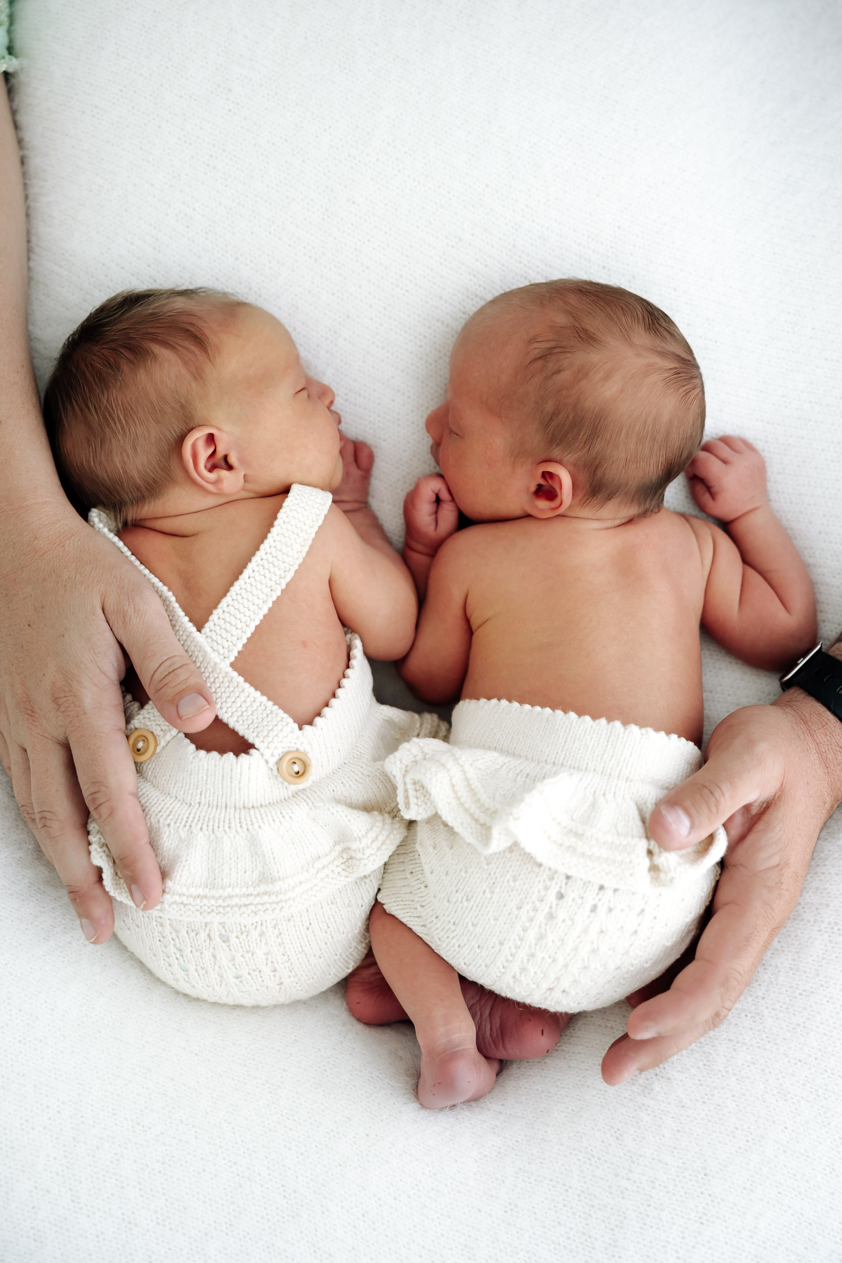 Twin newborn portraits in Mackay studio, newborn siblings posed together with gentle lighting and timeless styling.