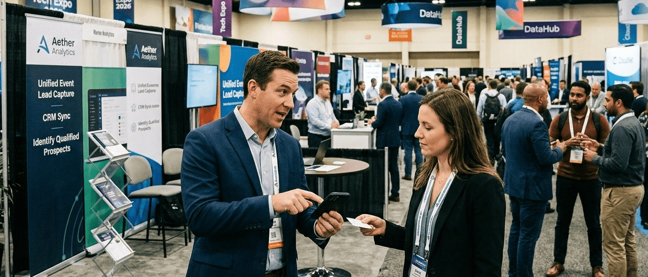 Sales representative using lead capture software to scan a business card during a trade show networking conversation.