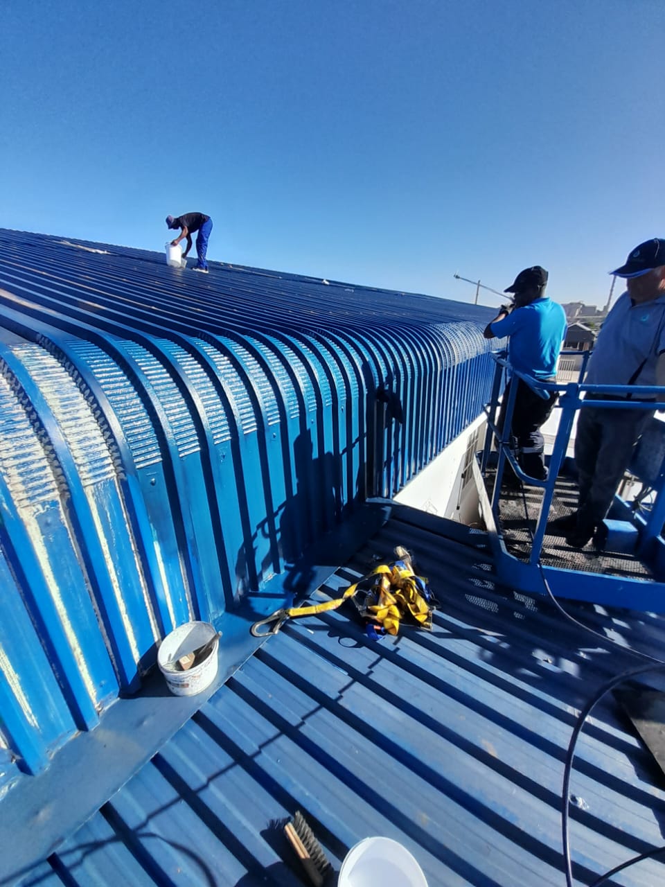 Industrial roof getting sprayed with waterproofiing rubber