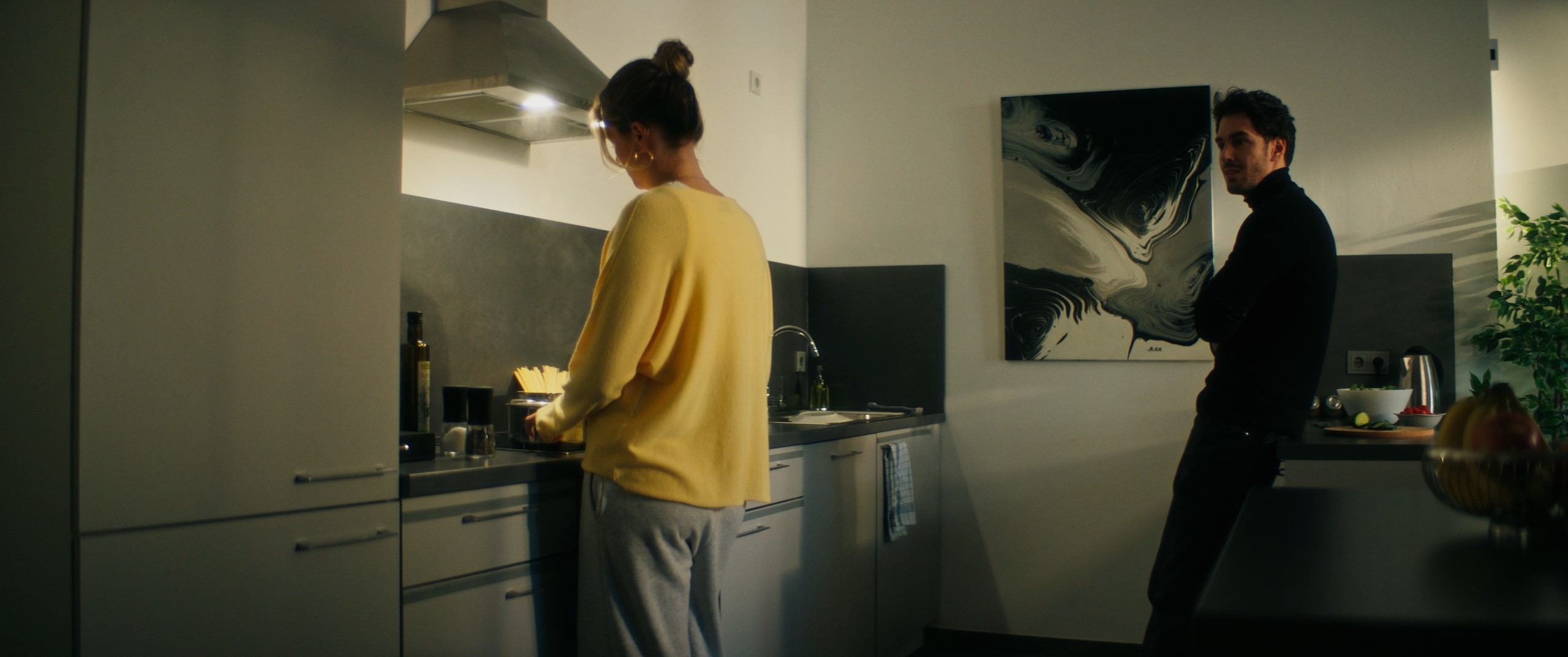 a couple stands in the kitchen