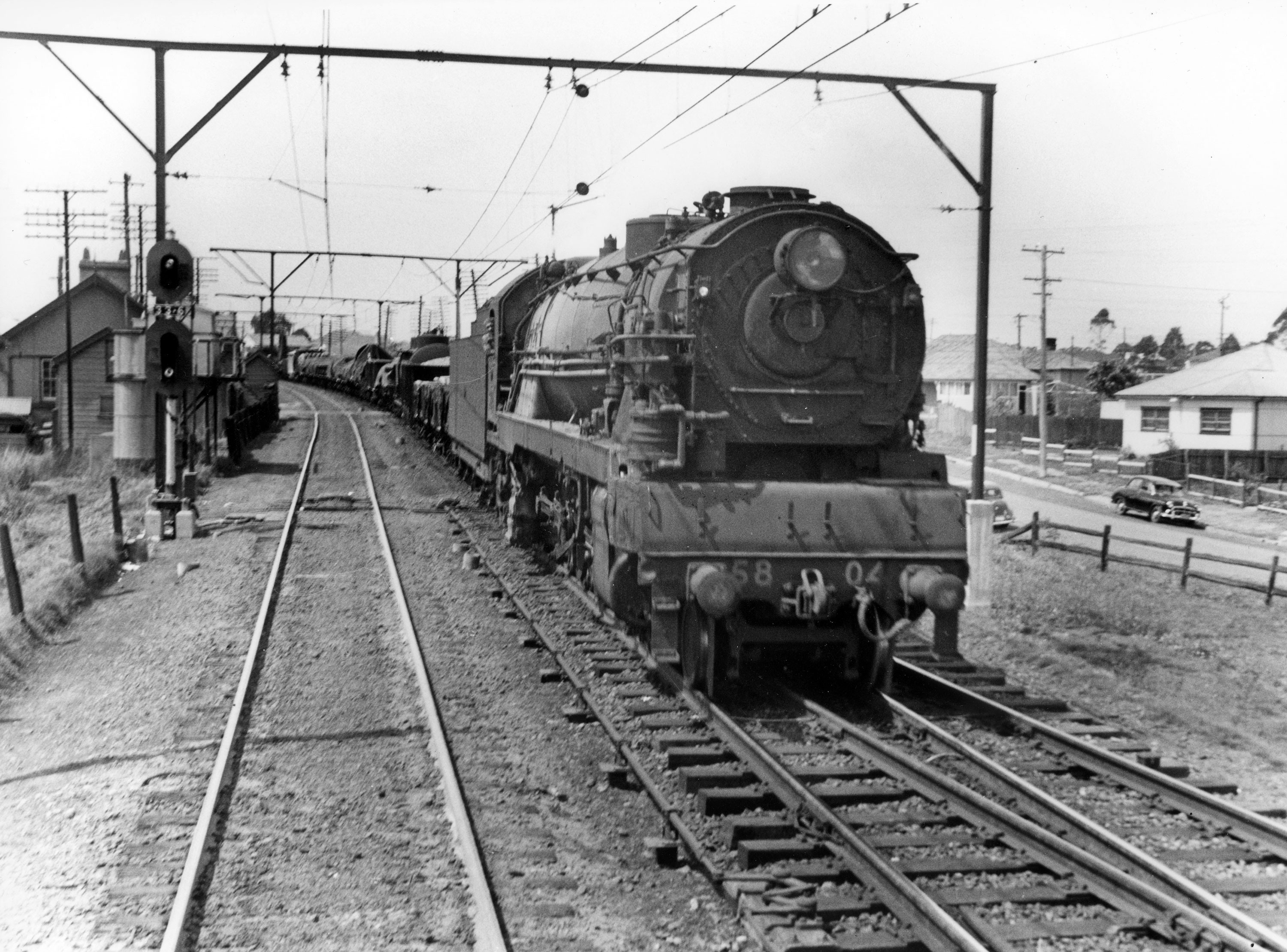 Locomotive 5804 is shown between Penrith and Blacktown heading a goods train towards Enfield yards. The engine entered service on 25 September 1950, receiving a heavy overhaul in May 1955 when it was fitted with new boiler 5804a. It was withdrawn from service in June 1957. -Deniss O'Brien Collection