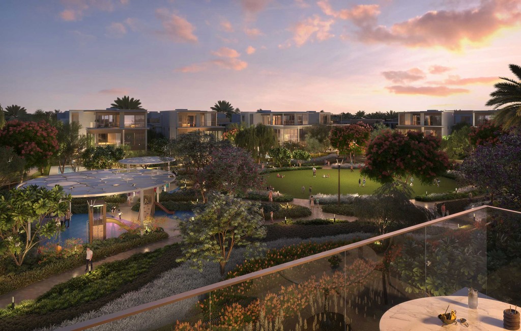 Sunset view from balcony of Nad Al Sheba Gardens resort: vibrant colors over landscape.