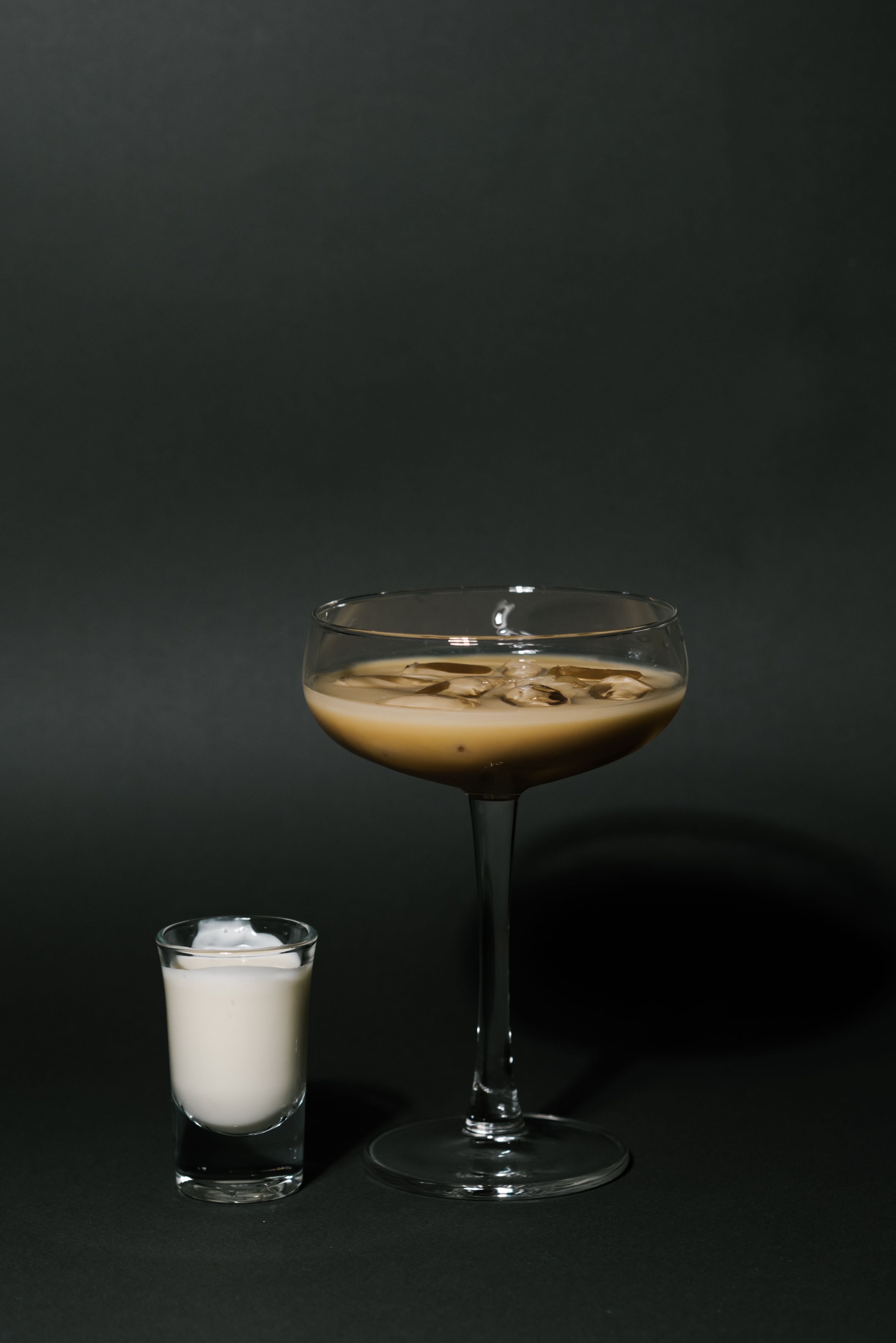 three clear drinking glasses with orange liquid